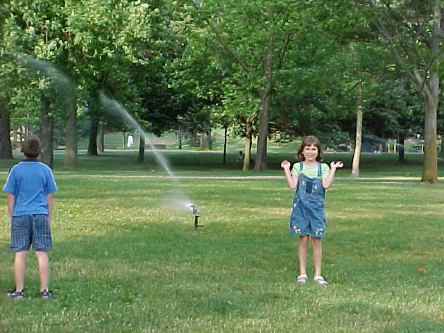 Children outdoors with sprinklers